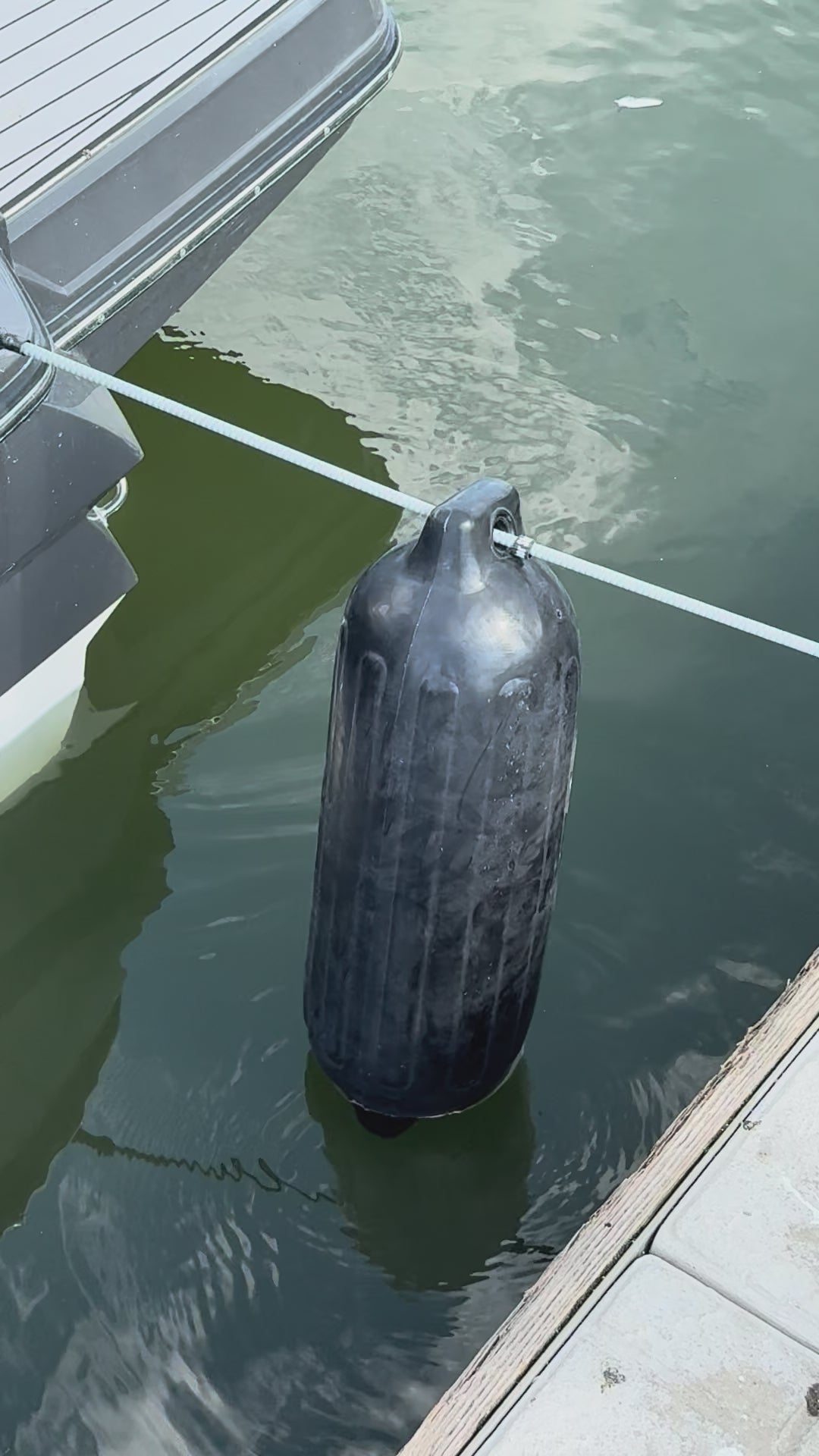 Bumper Shock video: silver shock line holding a marine bumper between a boat and the dock