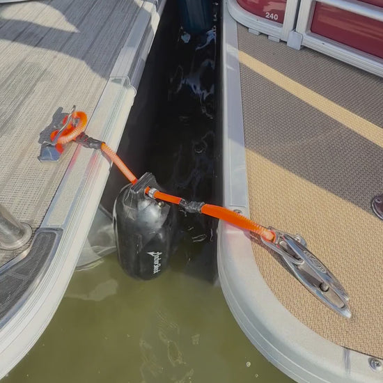 Bumper Shock video: orange shock line and marine bumper hung between two rafted pontoons to take the hit and stop the banging
